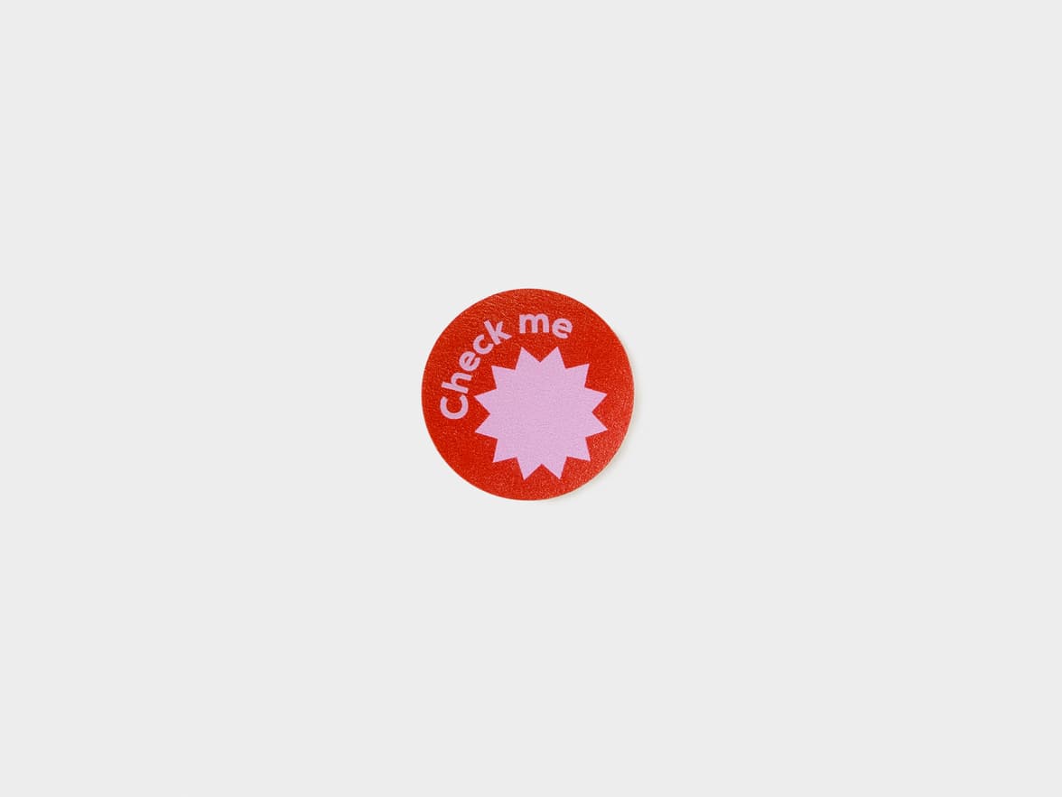 A customized round matte paper sticker in size 1 inch.